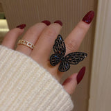 black butterfly ring on finger