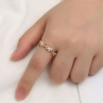 dainty gold butterfly ring on finger